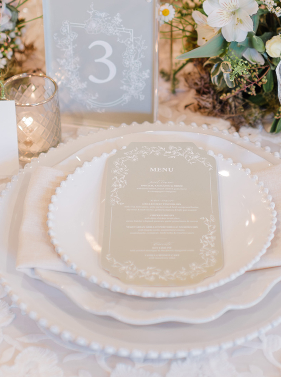 Glasses flatware and china on a beautiful table cloth for rent