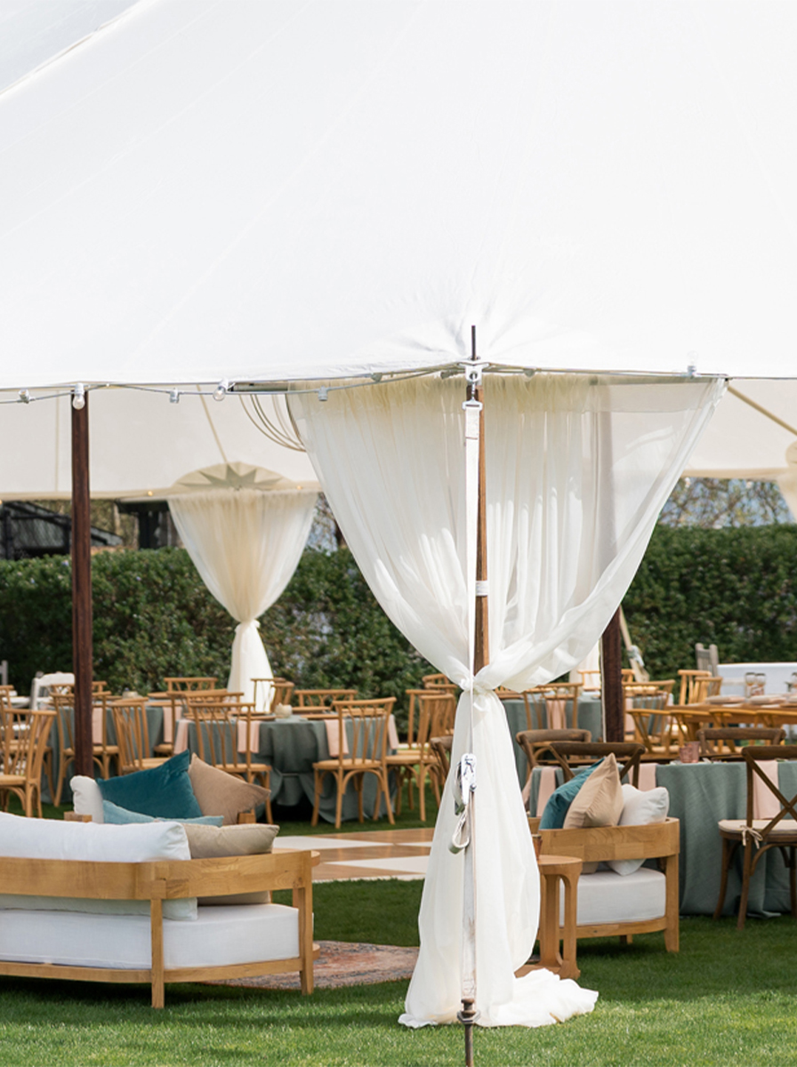 Glasses flatware and china on a table cloth with beautiful flowers for rent